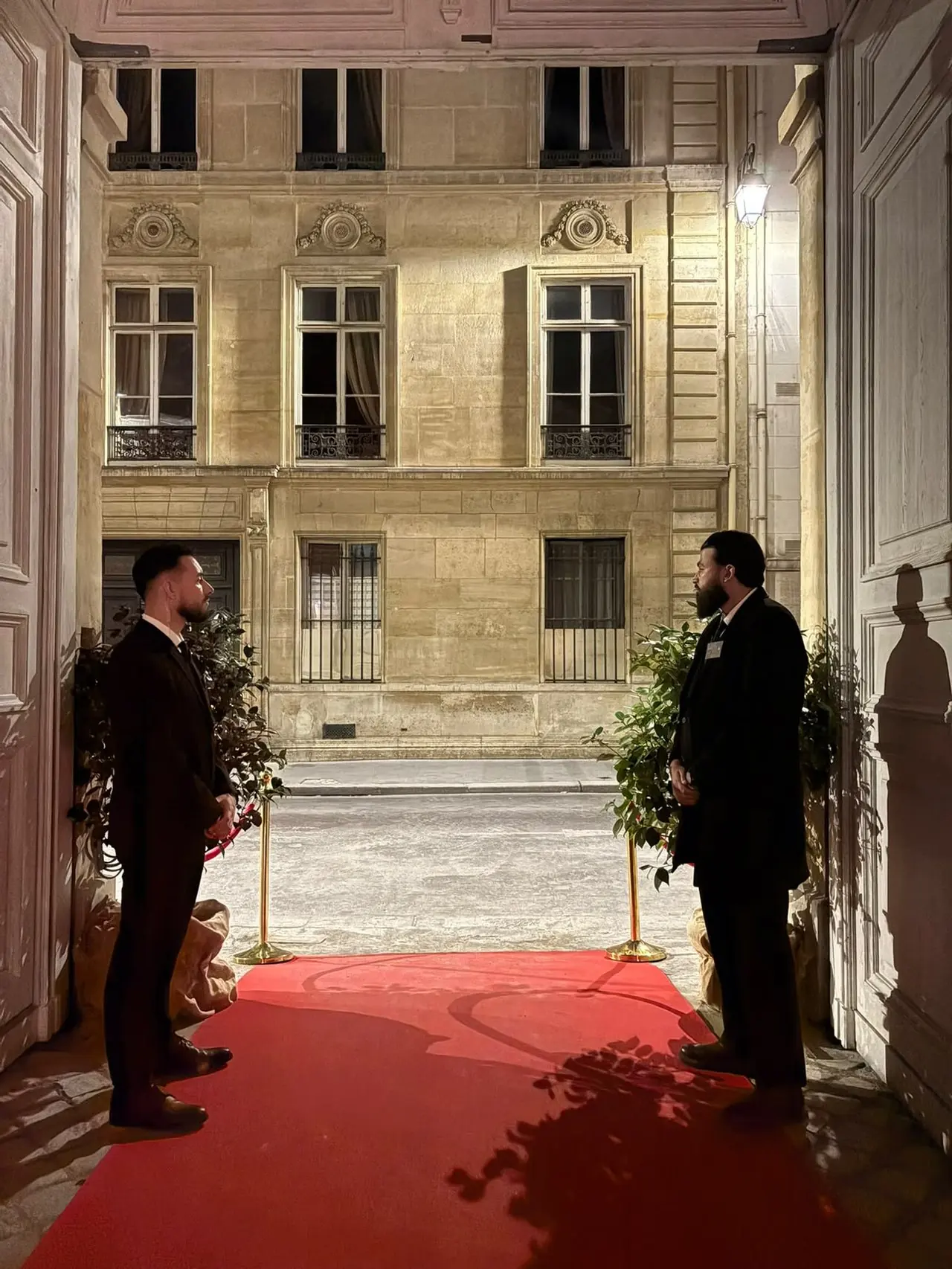 Deux agents NOX SECURITY en costume à l’entrée d’un hôtel particulier parisien, lors d’un mariage privé